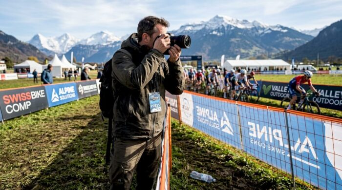 Photographer capturing live outdoor cycling event