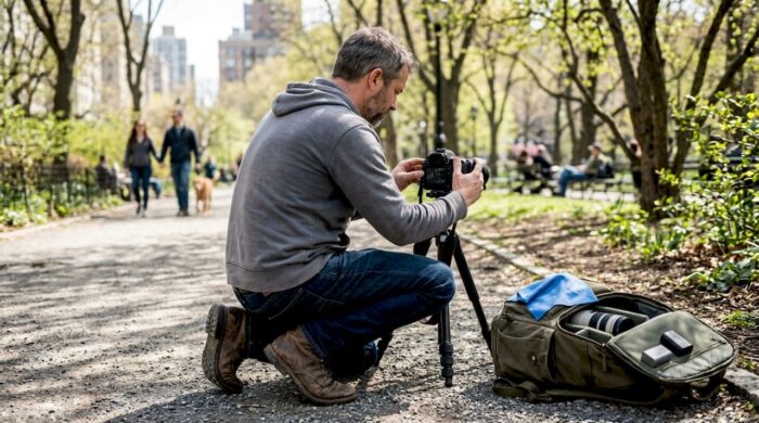 Photographer preparing action shot on park trail