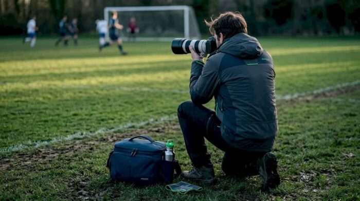 Sports photographer shooting action on sideline