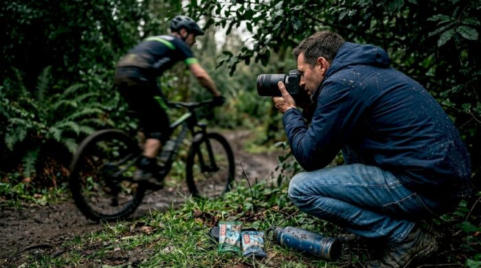 Photographer capturing mountain biker in action