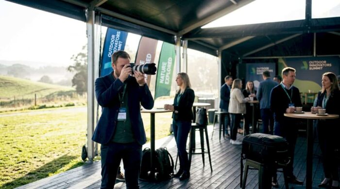Photographer capturing keynote at summit event
