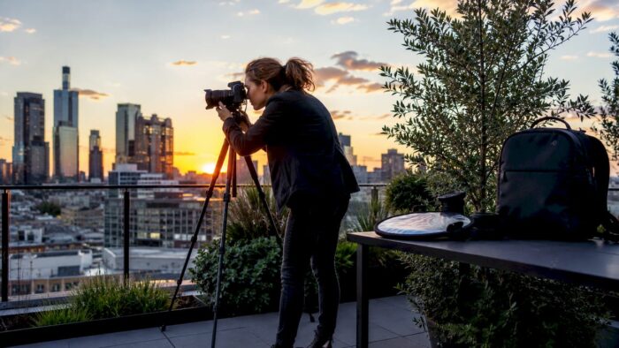 Corporate photographer preparing camera in office