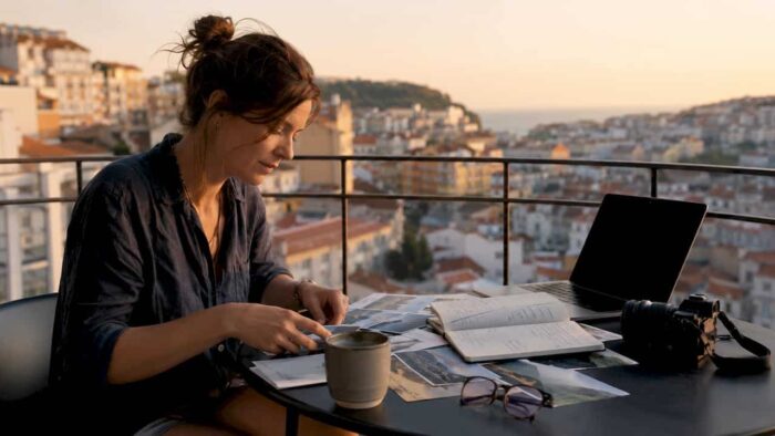Photographer organizing travel photo project at home