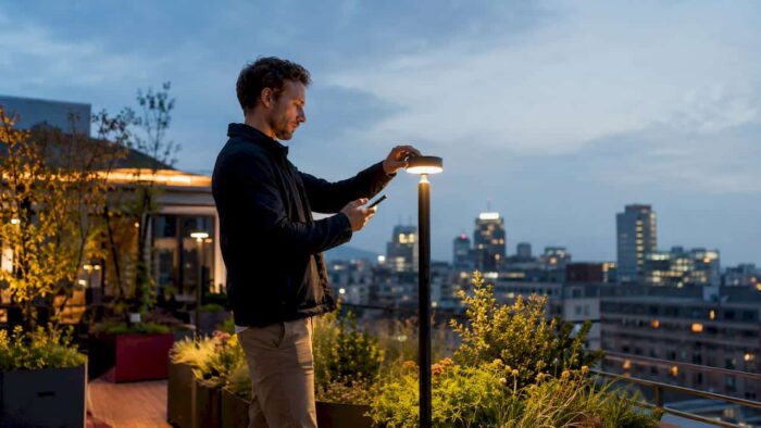 Landscape designer adjusting outdoor lighting system