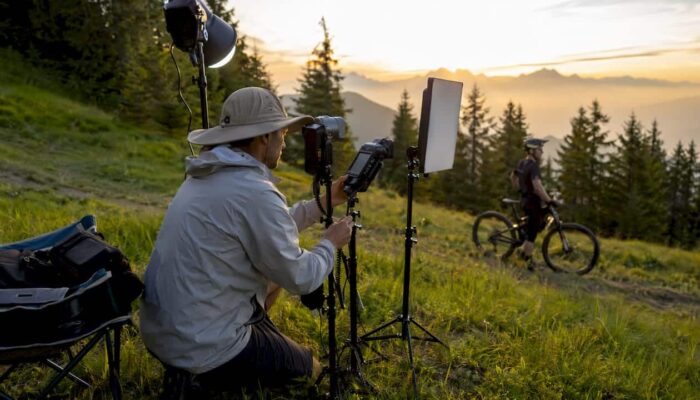 Photographer adjusting outdoor lighting for action shot