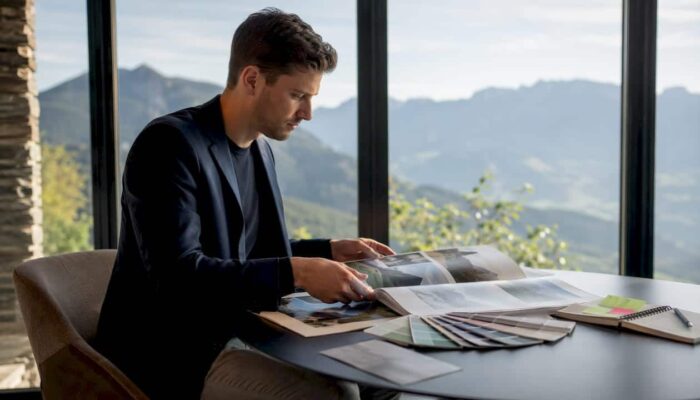 Brand manager reviewing photography portfolio at desk